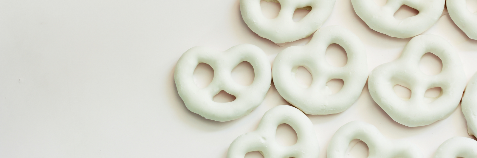 Dilettante Chocolates White Peppermint Chocolate Pretzels against a grey background