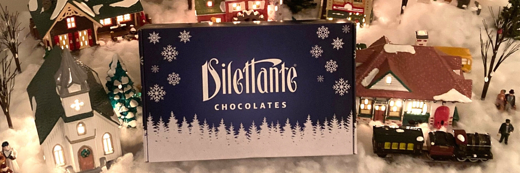 Dilettante Chocolates Holiday Gift Box in a Christmas Village
