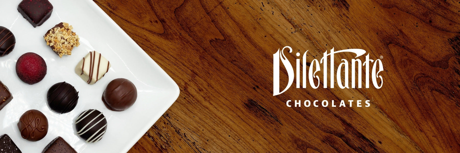 Dilettante Chocolates Hand-Dipped Chocolate Truffles on a White Plate