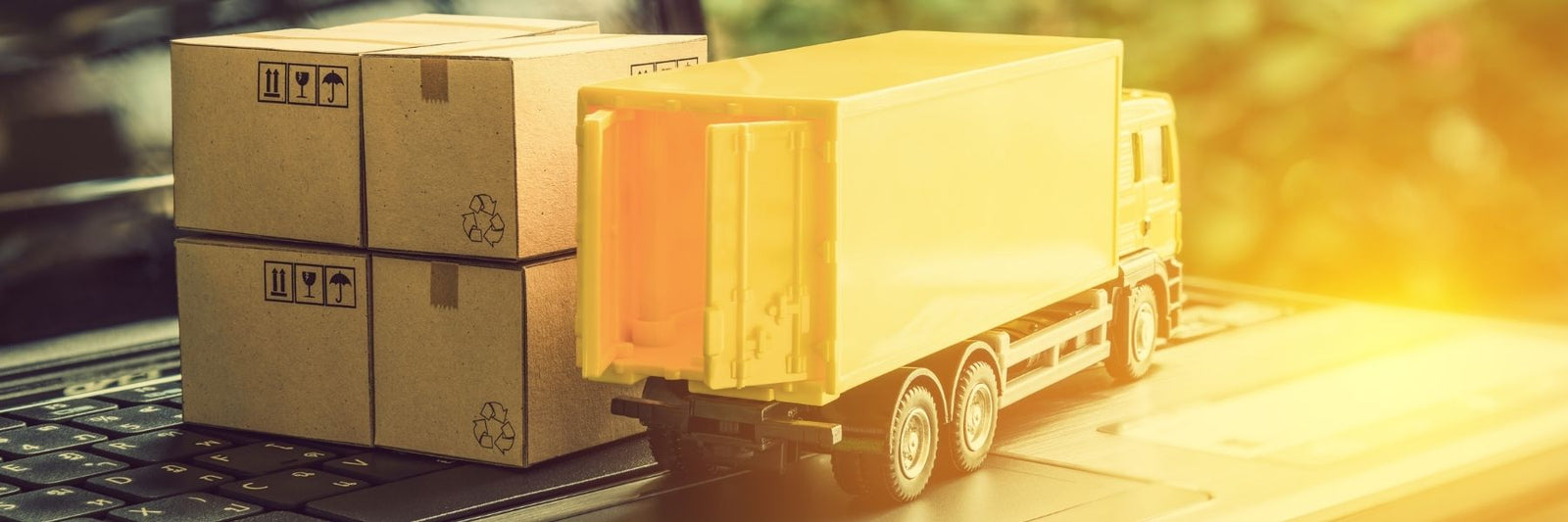 Dilettante Chocolates Toy truck with small packages on top of a laptop