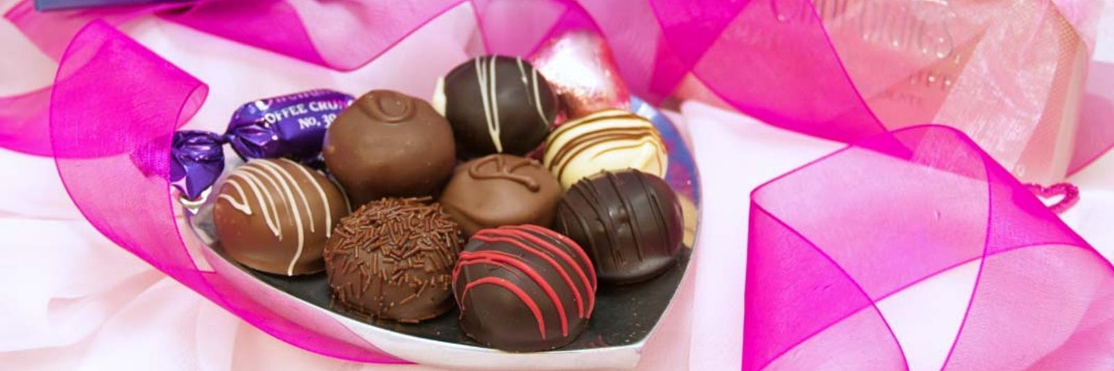 Dilettante Chocolate Truffles on a Heart-Shaped Plate with Pink Ribbon