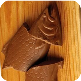 Dilettante Chocolates Milk Chocolate Covered Fish On A Cutting Board