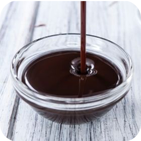 Dark Chocolate Sauce Poured Into a Glass