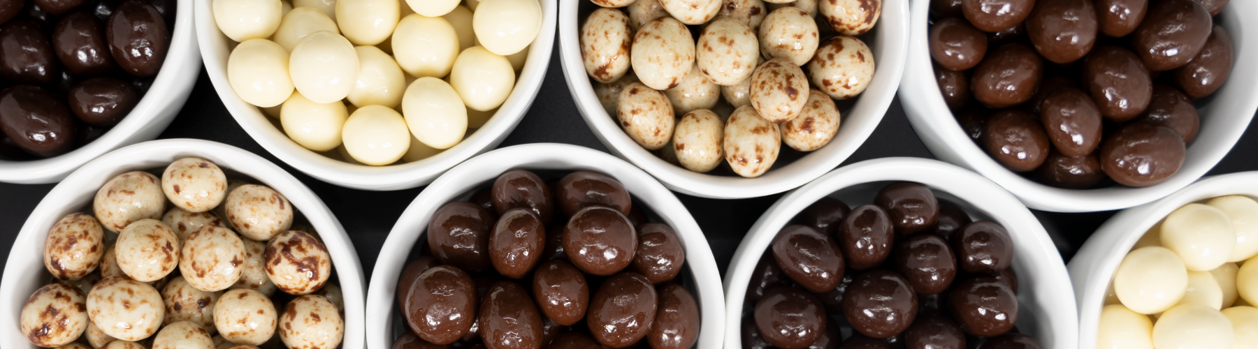 Bowls of White, Marbled, Milk, and Dark Chocolate-Covered Espresso Beans by Dilettante Chocolates