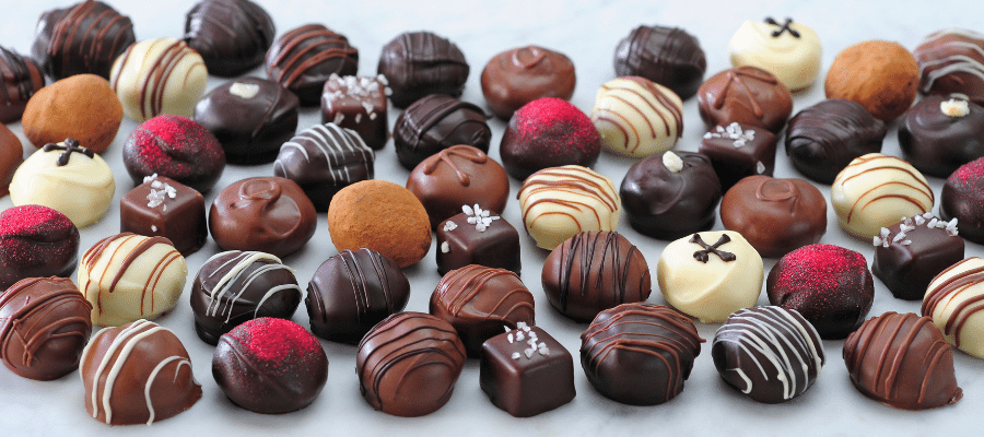 Taste remarkable flavor from Dilettante's white, dark, and milk chocolate truffles